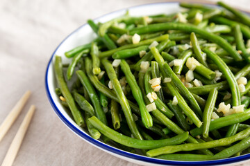 Homemade Asian Garlic Green Beans on a Plate, low angle view. Close-up.