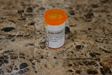 Closeup of a pharmaceutical container for 50 mg tablets.
