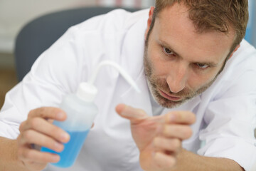 pleasant concentrated lab worker making an experiment