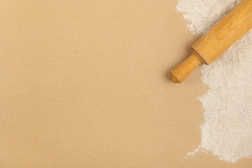 Rolling pin and rye flour on the table. Baking background.