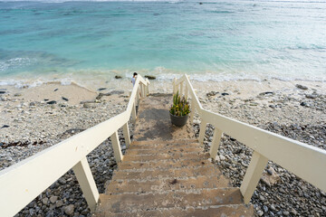 A stairway leading to a beach on a tropical Pacific island