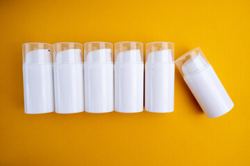 Container for cream, shampoo, toiletries, spa. Unbranded white plastic bottles. Bottle with a dispenser for cosmetic products. Skin care and beauty concept. Mockup style, copy space