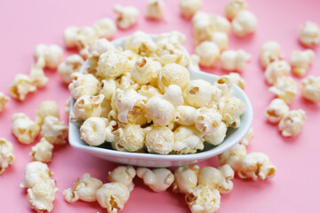 Sweet popcorn on pink background.