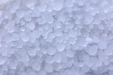 Selective focus of small ice balls (white hail) on the ground, The pellets of frozen rain which...