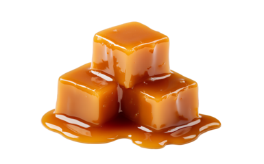 Sweet caramel candy cubes topped with caramel sauce on white background.