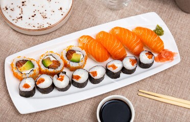 Japanese maki and urumaki roll with salmon and nigiri sushi served with soy sauce