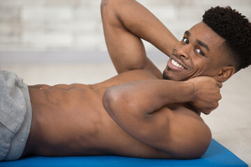 muscular man exercising doing sit up exercise