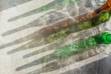 Empty bottles with creative shadows and fantastic highlights. Wastes of different glass containers ready for recycling. Separate collection of glass garbage. Eco friendly and zero waste concept