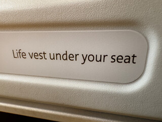 Life vest under your seat sign - 712773385