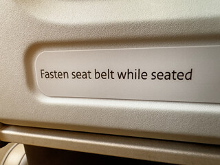 Fasten seat belt while seated sign - 712773391