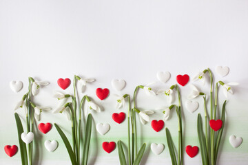 Snowdrop flowers and red and white martenitsa hearts of the Martisor holiday on March 1 on a...