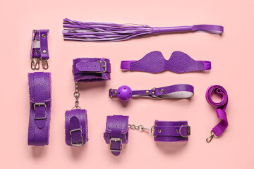 Purple sex toys on beige background