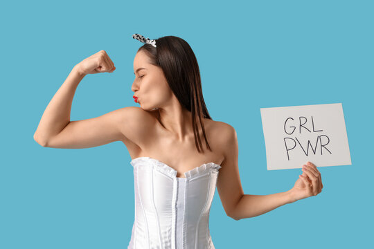 Portrait of strong pin-up woman showing muscles and holding sign with text GRL PWR on blue background. Women's History Month
