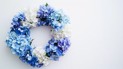 Floral wreath of blue and white hydrangea flowers against white background