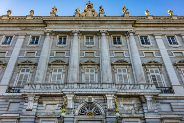 Architectural fragment of Spanish Royal Palace (Palacio Real, 18th century) in Madrid - official residence of the King of Spain, largest palace in Europe by floor area. Madrid, Spain.