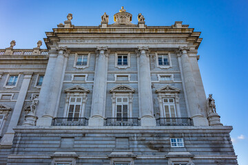 Fototapeta na wymiar Architectural fragment of Spanish Royal Palace (Palacio Real, 18th century) in Madrid - official residence of the King of Spain, largest palace in Europe by floor area. Madrid, Spain.