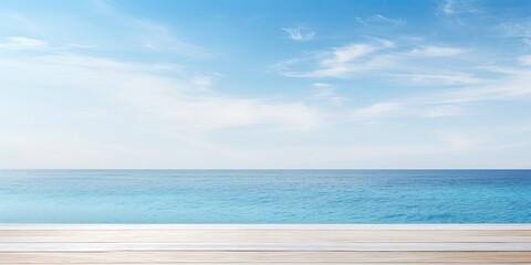 Blank white wooden table with blurred blue sky and sea background, suitable for summer holiday themes or product display.