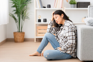 Obraz premium Photo with copy space of a hopeless chinese woman sitting depressed at home