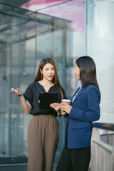 Obraz premium Business team walking and talking on street in city Outside Office and drinking coffee together, partners, teamwork.