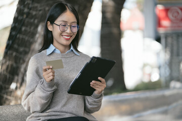 Women hold credit cards, conduct financial transactions via smartphone. Work place. Lifestyle.