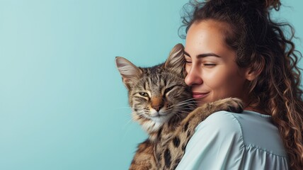 Woman affectionately cuddling with her tabby cat