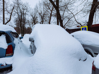 Car under snow after blizzard and snowfall
