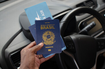 Hand holding the Brazilian passport in a close-up, symbolizing the journey and national identity.