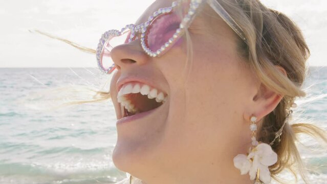 Happy laughter female portrait going crazy about exciting news. Super excited smiling lady with white teeth laughing out loud outdoors. Emotional woman looking at camera. Positive energy concept 4K