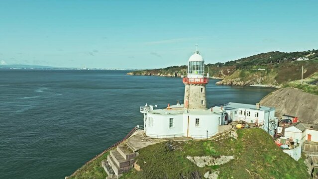 aerial reveal of a lighthouse on top of a cliff, irish landscape