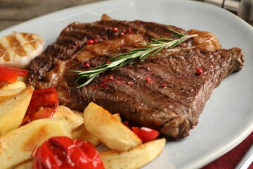 Delicious grilled beef steak and vegetables on plate, closeup