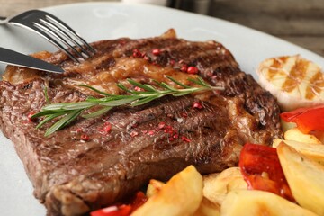 Delicious grilled beef steak and vegetables on plate, closeup