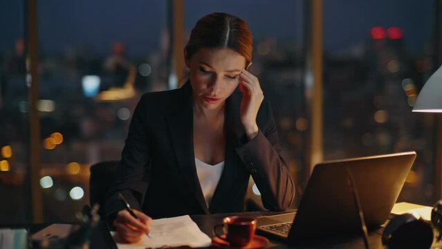 Woman overwork late office typing laptop. Busy manager analysing papers report