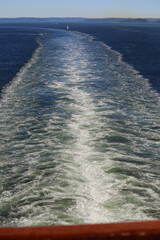 Water trail in ocean behind cruiseship