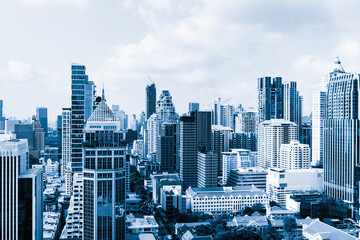 Naklejka na ściany i meble Closeup image of Bangkok cityscape. Modern skyscrapers with monochrome blue filter. Modern architectural building skyline with blue sky. Side view. Business background. Day light. Ornamented.