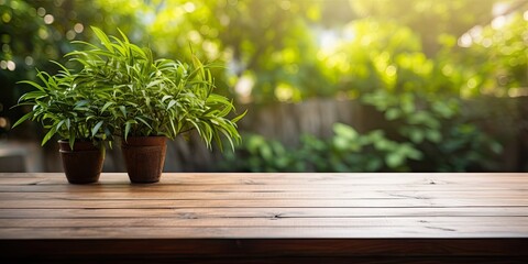 Green plants provide a background for an unfurnished wooden table in a summer backyard or patio.