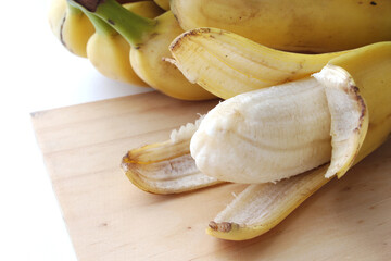 Delicious peeled apple banana on the table.