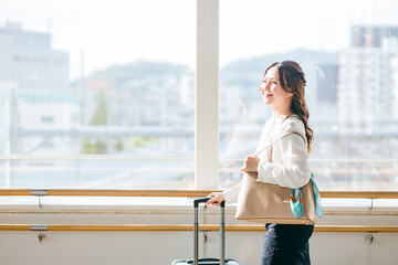 Fototapeta premium 駅の跨線橋を歩く観光・旅行・女子旅をする女性（一人旅・国内旅行・休暇） 