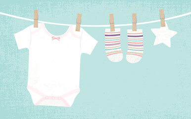 Baby girl clothes pinned to a clothesline, in a cut paper style with textures
