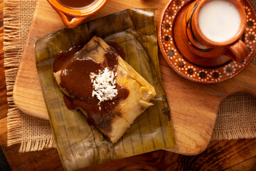 Oaxacan Tamale. Prehispanic dish typical of Mexico and some Latin American countries. Corn dough wrapped in banana leaves. The tamales are steamed.