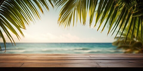 Tropical beach photo with green palm leaf and wooden table for product advertisement.