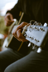 Photo detail of unknown person playing an acoustic guitar. Concept of hobbies.