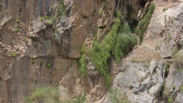 Rocks revealing a view of Holy Kipinas Monastery. The monastery was built into a cliff overhanging a narrow mountain road and a deep gorge.