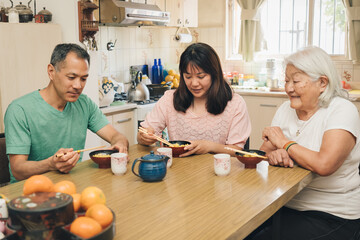 Japanese adult family eating rice with chopsticks.