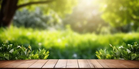  Wooden table displaying products with a lush spring garden backdrop of green grass, leaves, and sunlight. © Sona