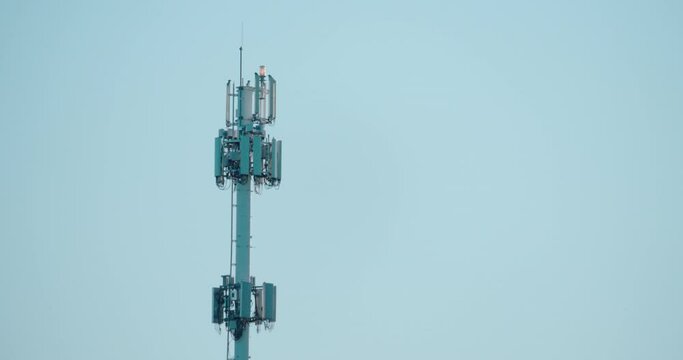 Cell phone antenna tower in blue sky