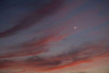 Crescent moon at mesmerizing sunset sky.