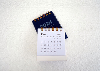 February 2024. Desk calendar for February 2024 on the table.