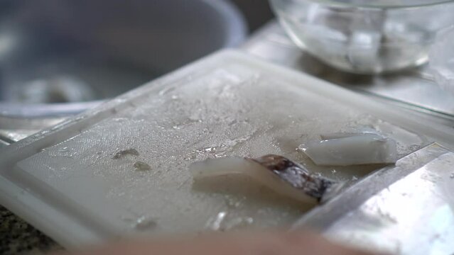 Woman hands knife cutting fresh squid cuttlefish cleaning preparing seafood home kitchen
