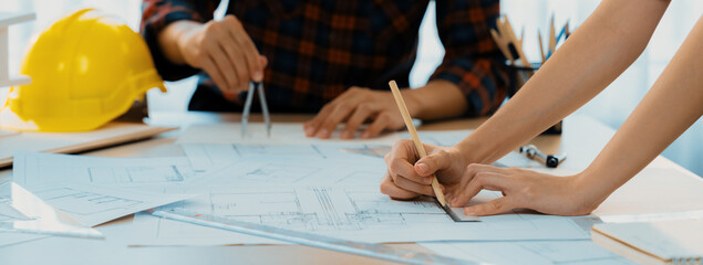Cropped image of cooperative architect team decide and work together on meeting table with house...
