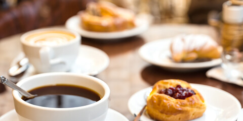 Coffee and Croissants on a White Table in a Cozy Cafe with Hot Espresso and Sweet Pastries
